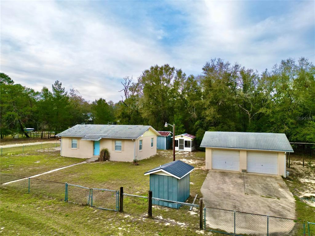 600 Wakulla Street Florahome, FL 32140 - Photo 33 of 47 an aerial view of a house with swimming pool garden view and trees