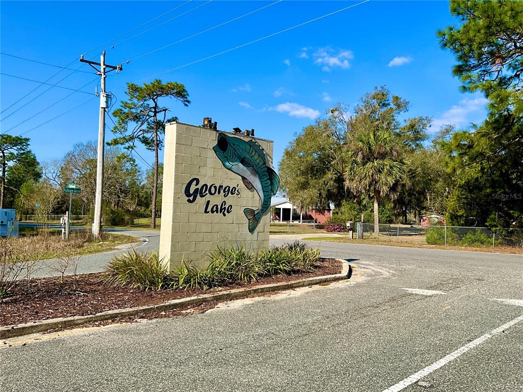 600 Wakulla Street Florahome, FL 32140 - Photo 38 of 47 a sign board with flower plants and wooden fence
