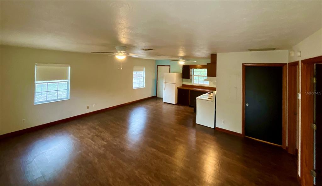 600 Wakulla Street Florahome, FL 32140 - Photo 7 of 47 an empty room with wooden floor and windows