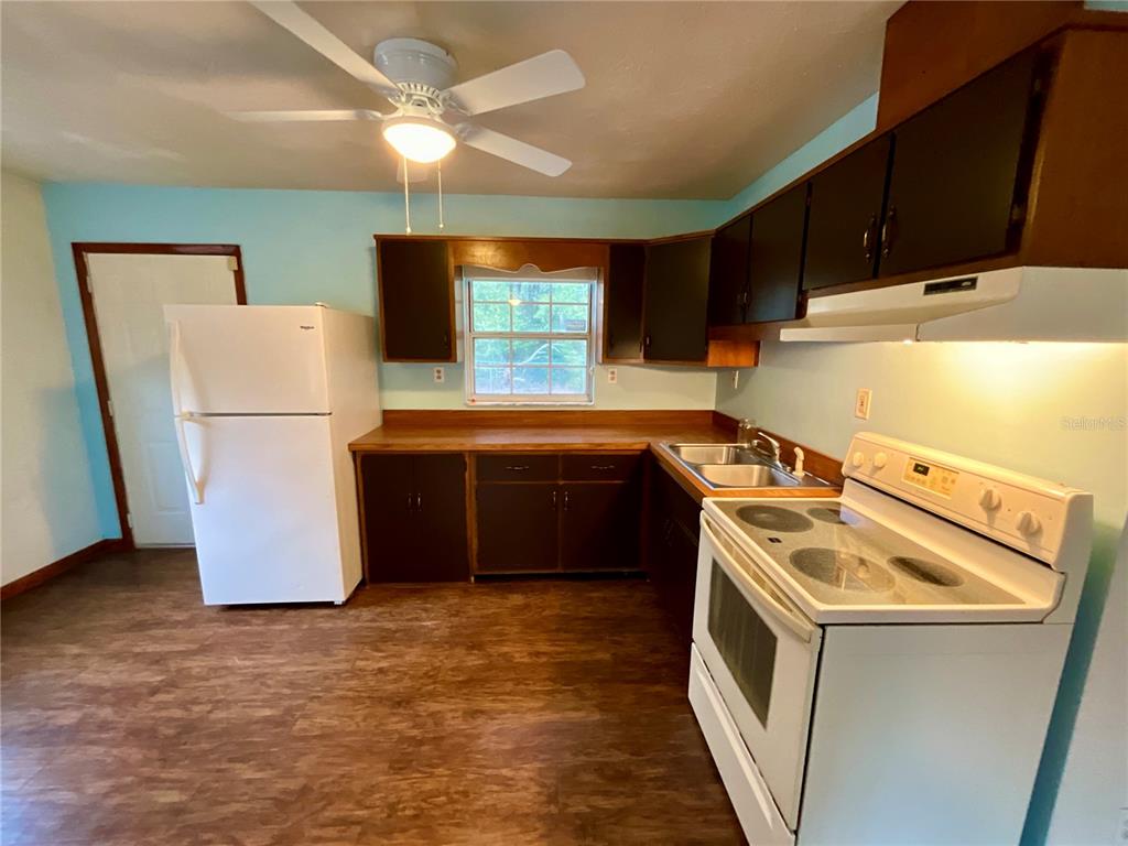600 Wakulla Street Florahome, FL 32140 - Photo 8 of 47 a kitchen with a refrigerator sink and cabinets
