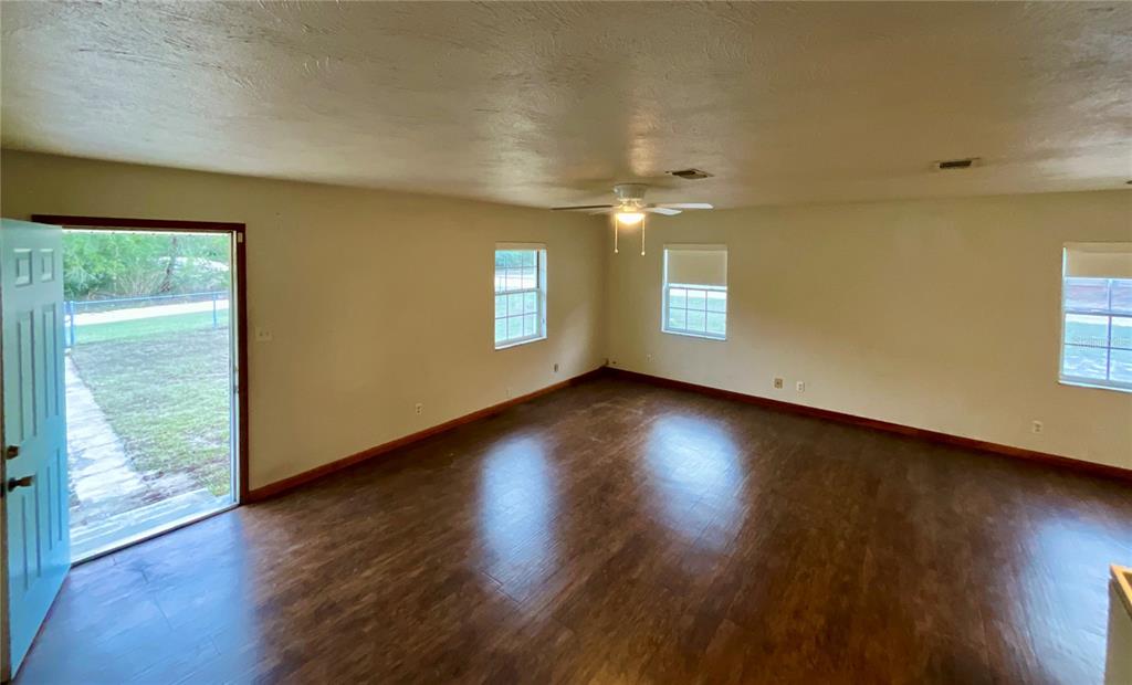 600 Wakulla Street Florahome, FL 32140 - Photo 10 of 47 an empty room with wooden floor and windows