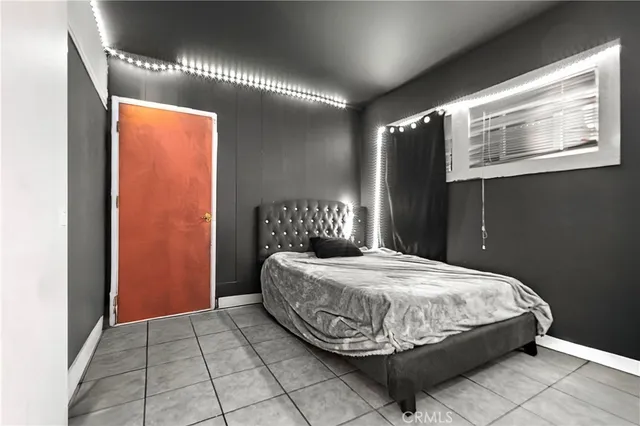 a bedroom with a large bed and a window