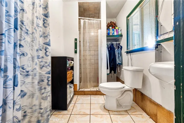 a bathroom with a toilet and a shower