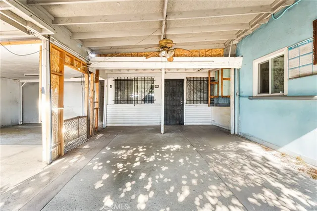a view of a porch with a table and chairs