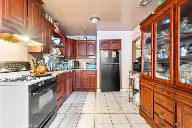 a kitchen with stainless steel appliances granite countertop a refrigerator and a stove