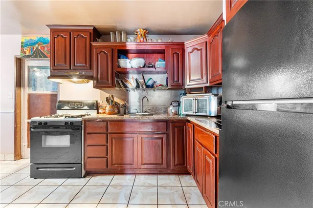 a kitchen with stainless steel appliances granite countertop a stove and a refrigerator