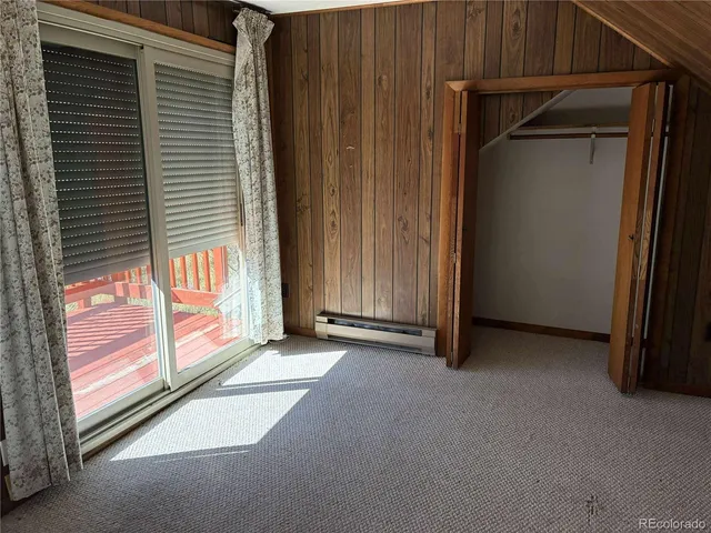 a view of a yard with plants and trees