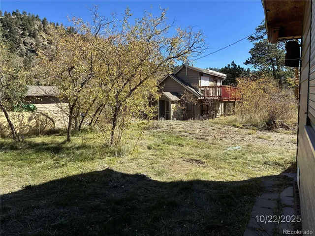 a bathroom with a granite countertop sink a mirror and shower