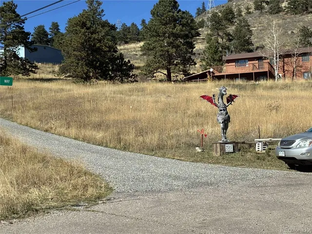 a street sign on a wall next to road