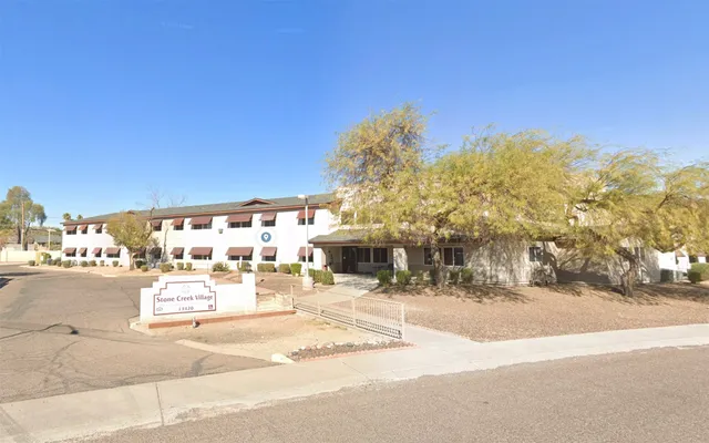 a front view of a building with sitting area