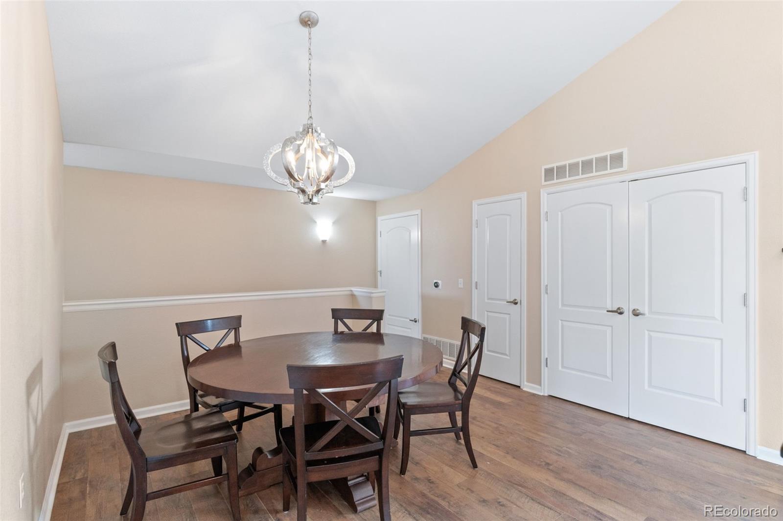 8540 Gold Peak Lane, Unit C Highlands Ranch, CO 80130 - Photo 16 of 37 a view of a dining room with furniture and wooden floor