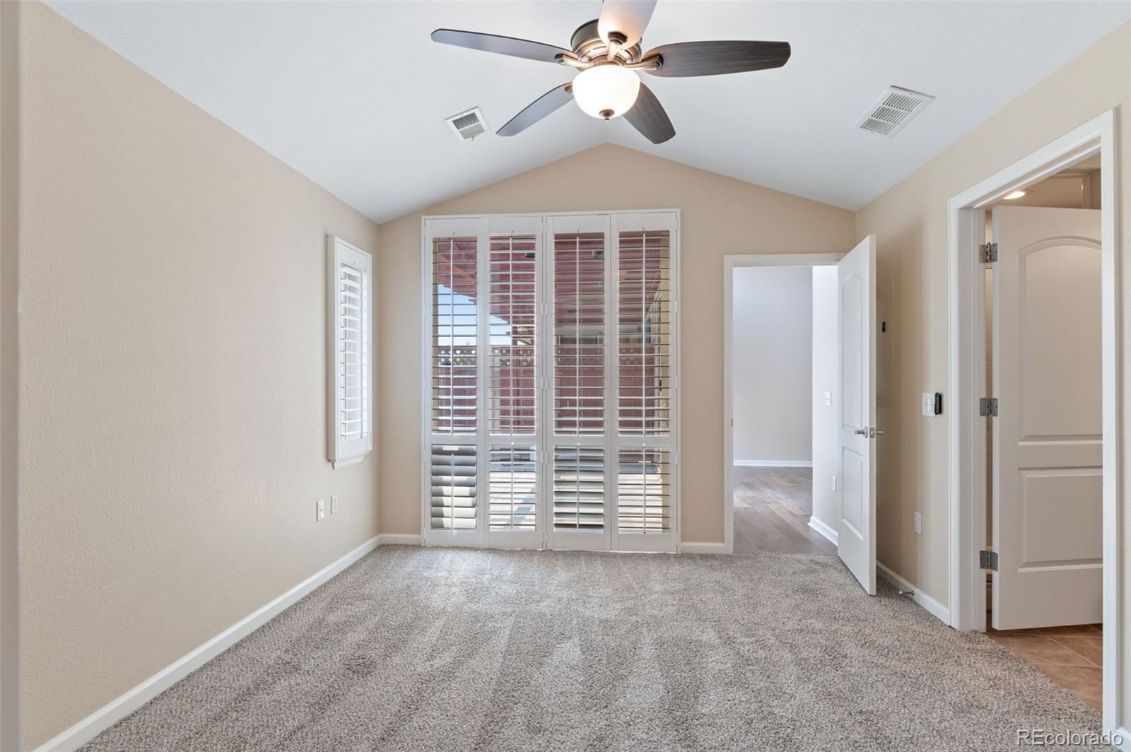 8540 Gold Peak Lane, Unit C Highlands Ranch, CO 80130 - Photo 20 of 37 an empty room with windows and fan
