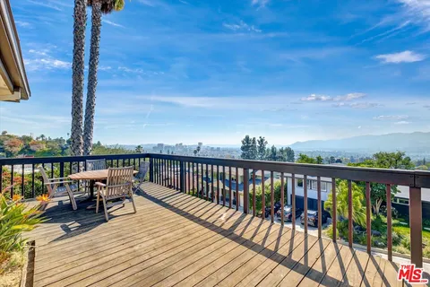 a view of a house with swimming pool and sitting area
