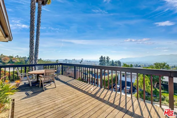 a view of a house with swimming pool and sitting area
