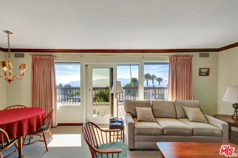 a living room with furniture and a lamp