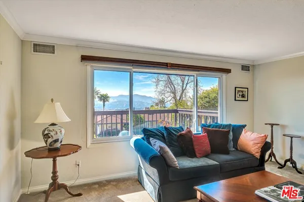 a view of a house with a yard and sitting area