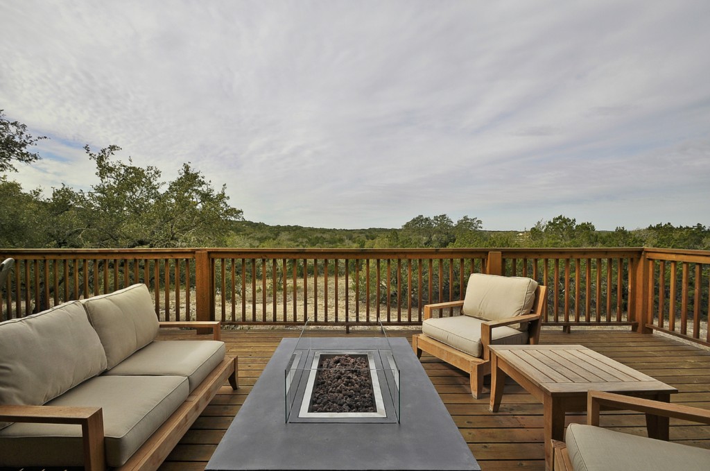 a balcony with wooden floor and furniture