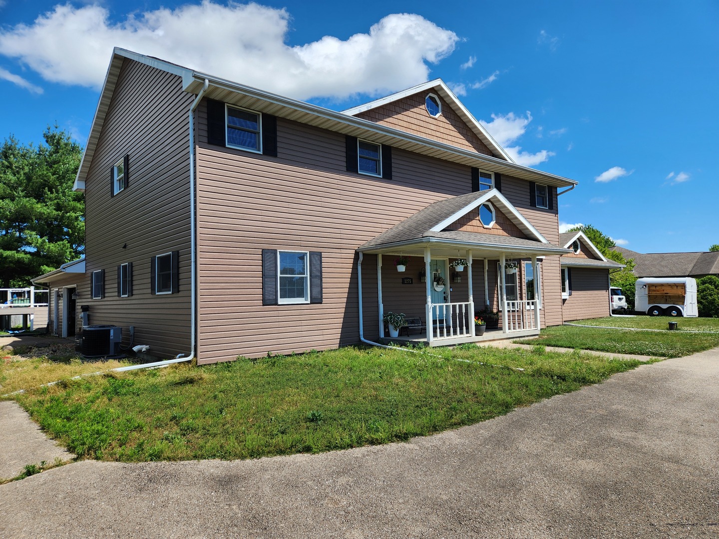 1275 Winn Road Sterling, IL 61081 - Photo 1 of 29 a view of a white house with a small yard and potted plants