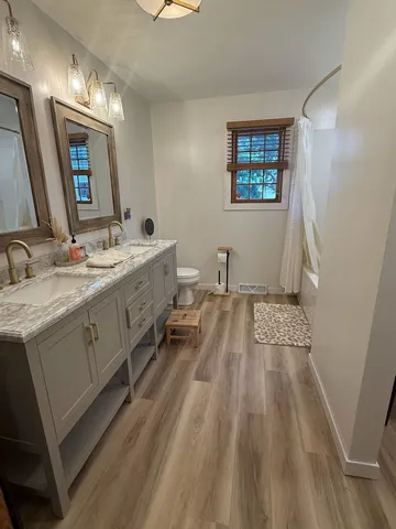 a spacious bathroom with a double vanity sink and a mirror
