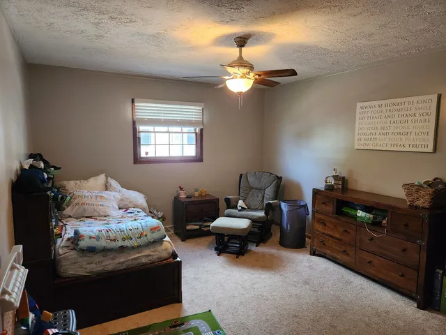 a bedroom with bed and a window