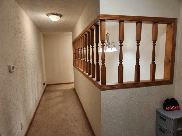 a view of a hallway with wooden floor and entryway