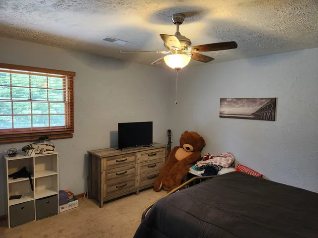 a bedroom with a bed and furniture