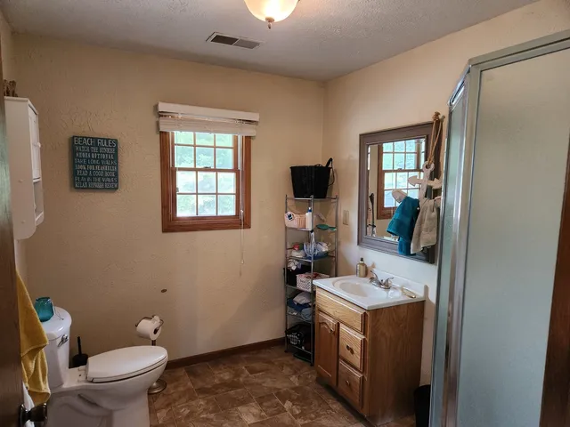 a bathroom with a sink toilet and mirror