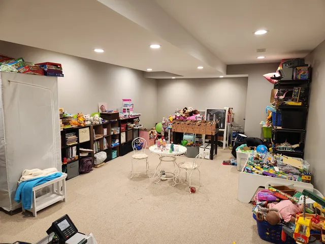 a kitchen with a refrigerator and lots of furniture