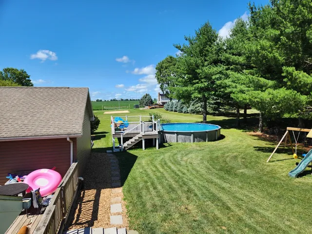 a view of a house with backyard porch and sitting area