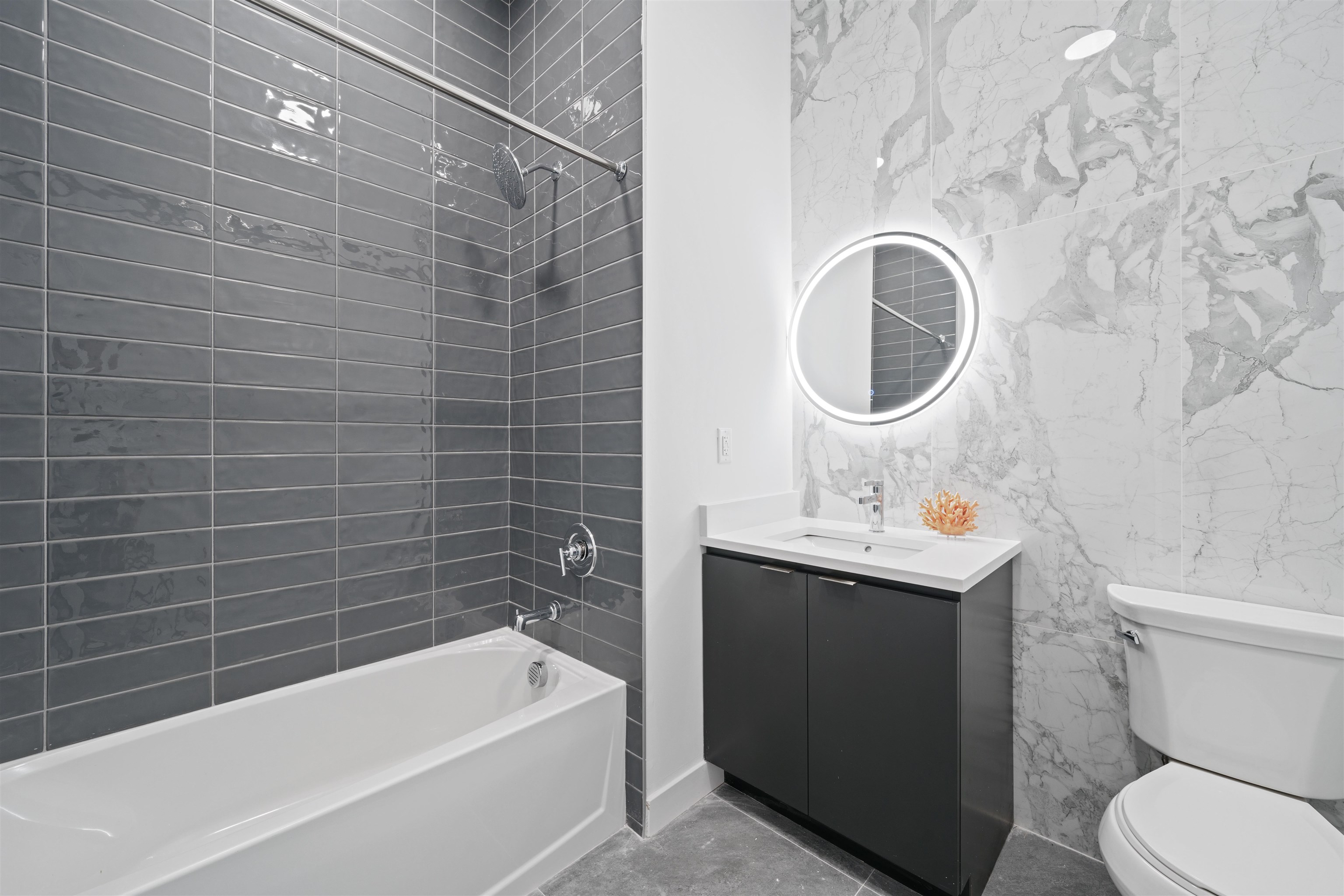 17 Ave East, Unit 504 Bayonne, NJ 07002 - Photo 12 of 30 a bathroom with a sink a toilet and bathtub