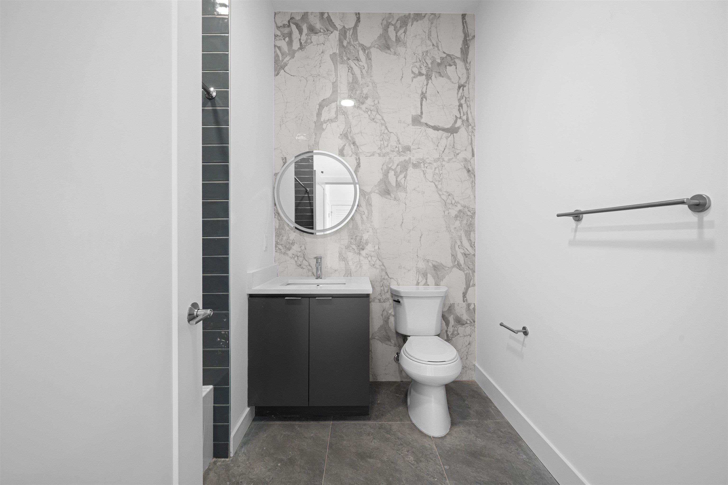 17 Ave East, Unit 504 Bayonne, NJ 07002 - Photo 13 of 30 a bathroom with a granite countertop toilet and a sink