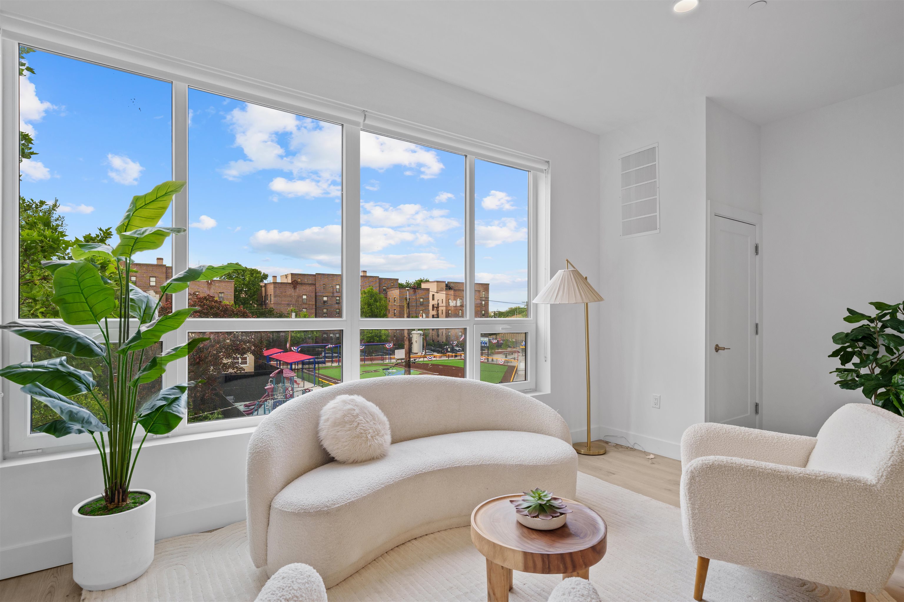 17 Ave East, Unit 504 Bayonne, NJ 07002 - Photo 2 of 30 a living room with furniture and a potted plant