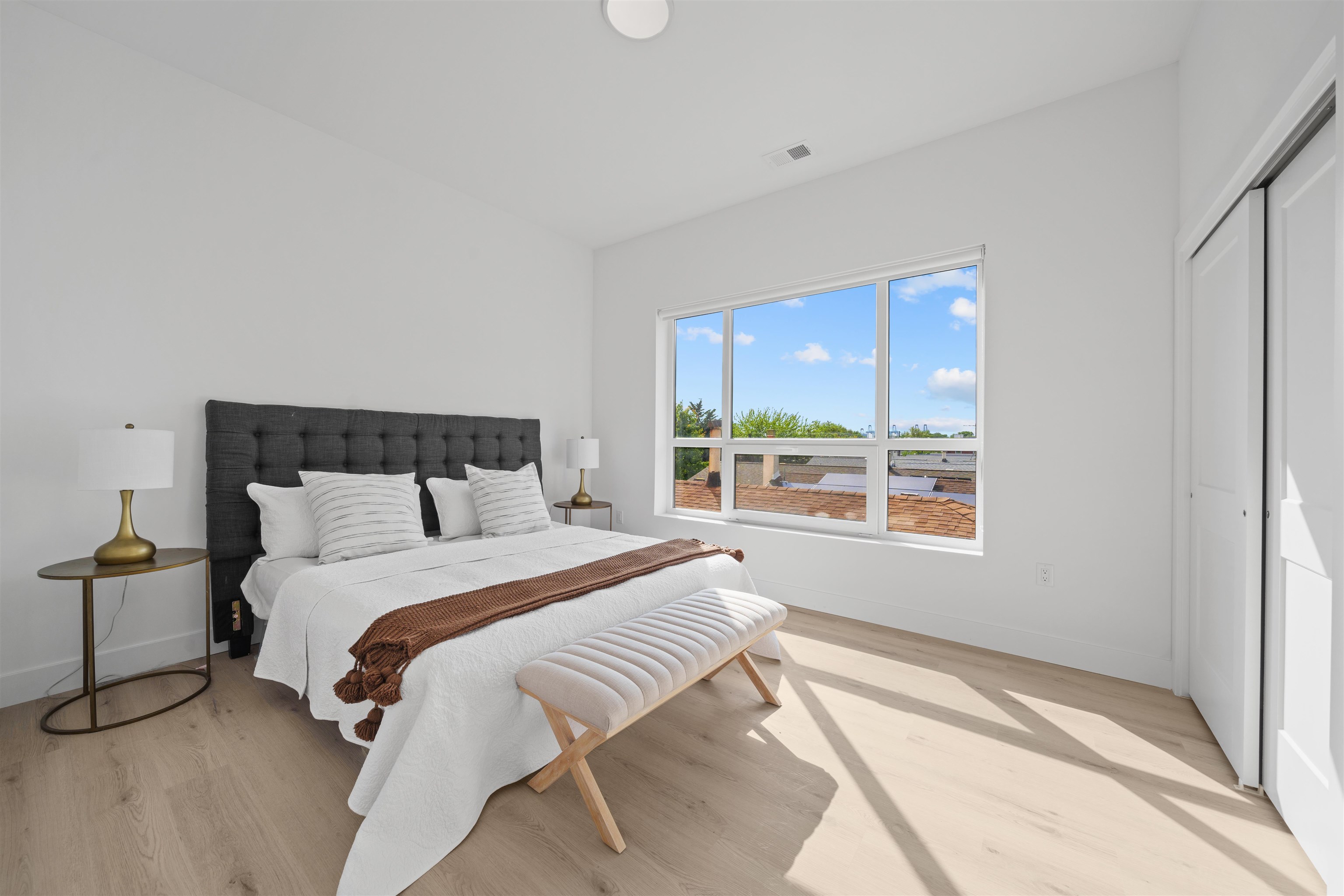 17 Ave East, Unit 504 Bayonne, NJ 07002 - Photo 6 of 30 a bedroom with a large bed and a large window