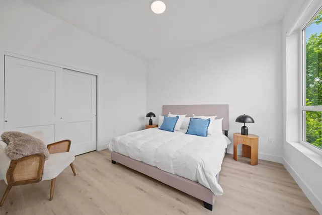 a bedroom with a bed and a window