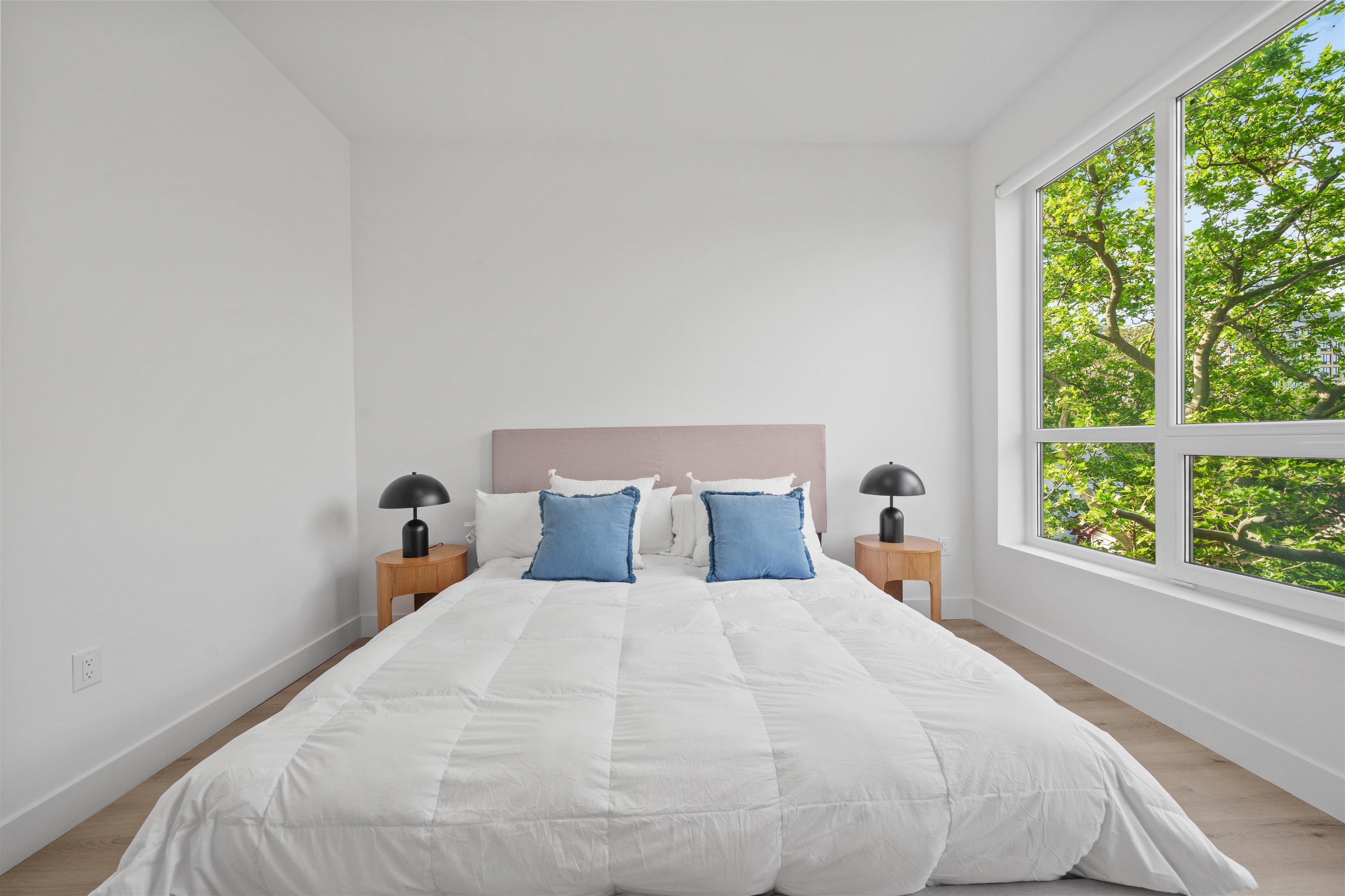 17 Ave East, Unit 504 Bayonne, NJ 07002 - Photo 9 of 30 a large bed sitting in a bedroom next to a window