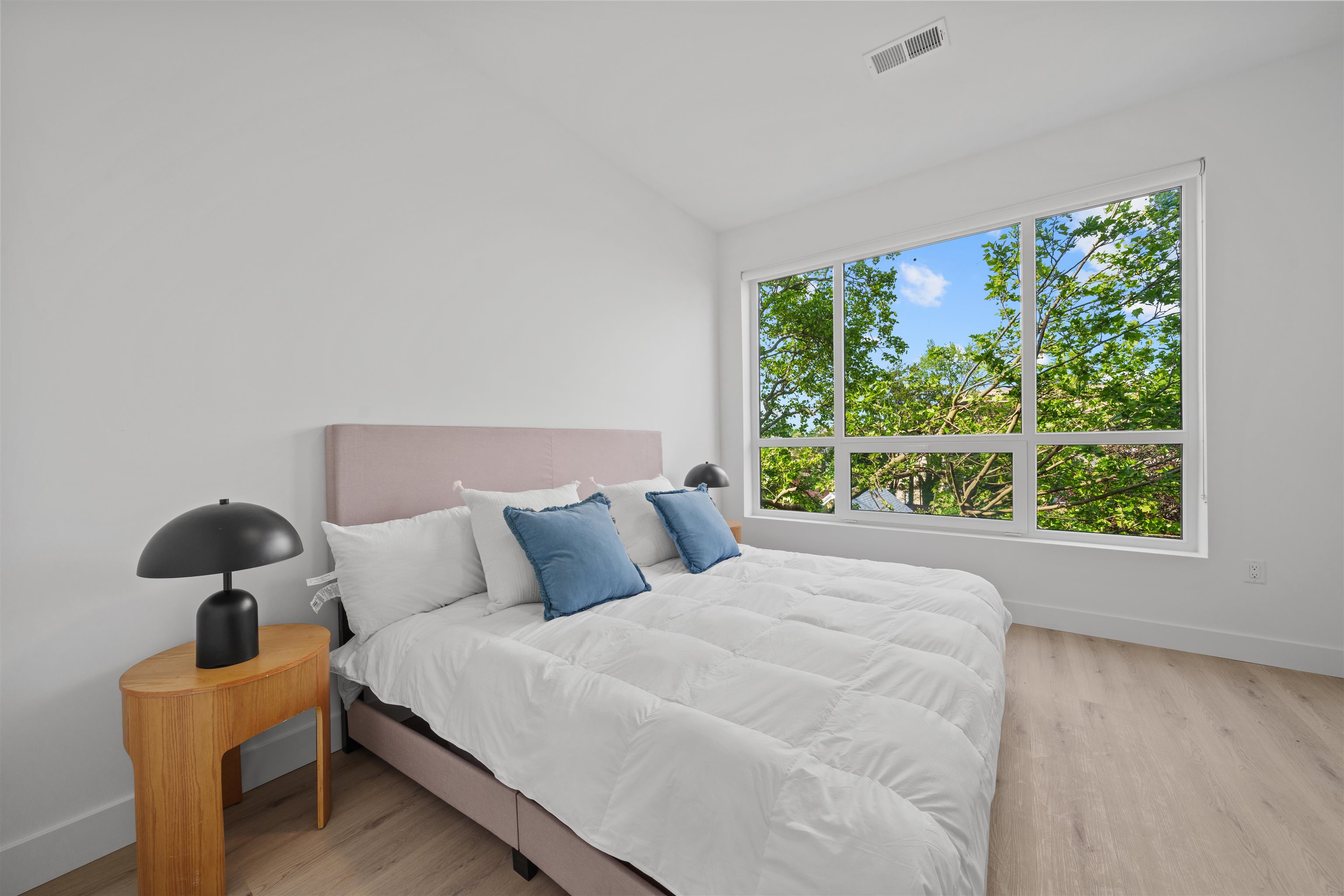 17 Ave East, Unit 504 Bayonne, NJ 07002 - Photo 10 of 30 a bedroom with a bed and a large window