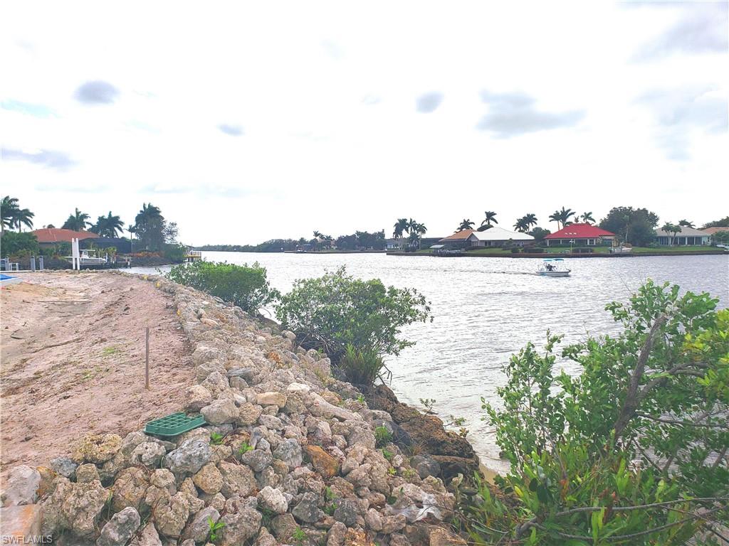 149 Venus Cay Naples, FL 34114 - Photo 12 of 21 a view of a lake with houses in the back