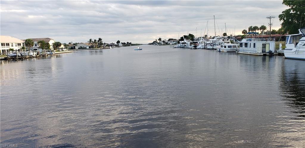 149 Venus Cay Naples, FL 34114 - Photo 21 of 21 a view of a lake with boats and trees in the background