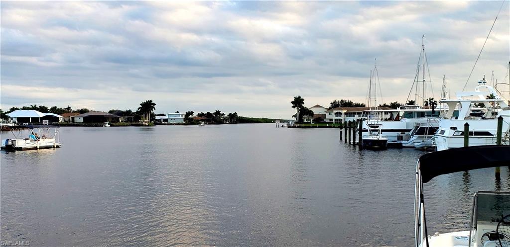 149 Venus Cay Naples, FL 34114 - Photo 6 of 21 a view of ocean with boats and trees in the background