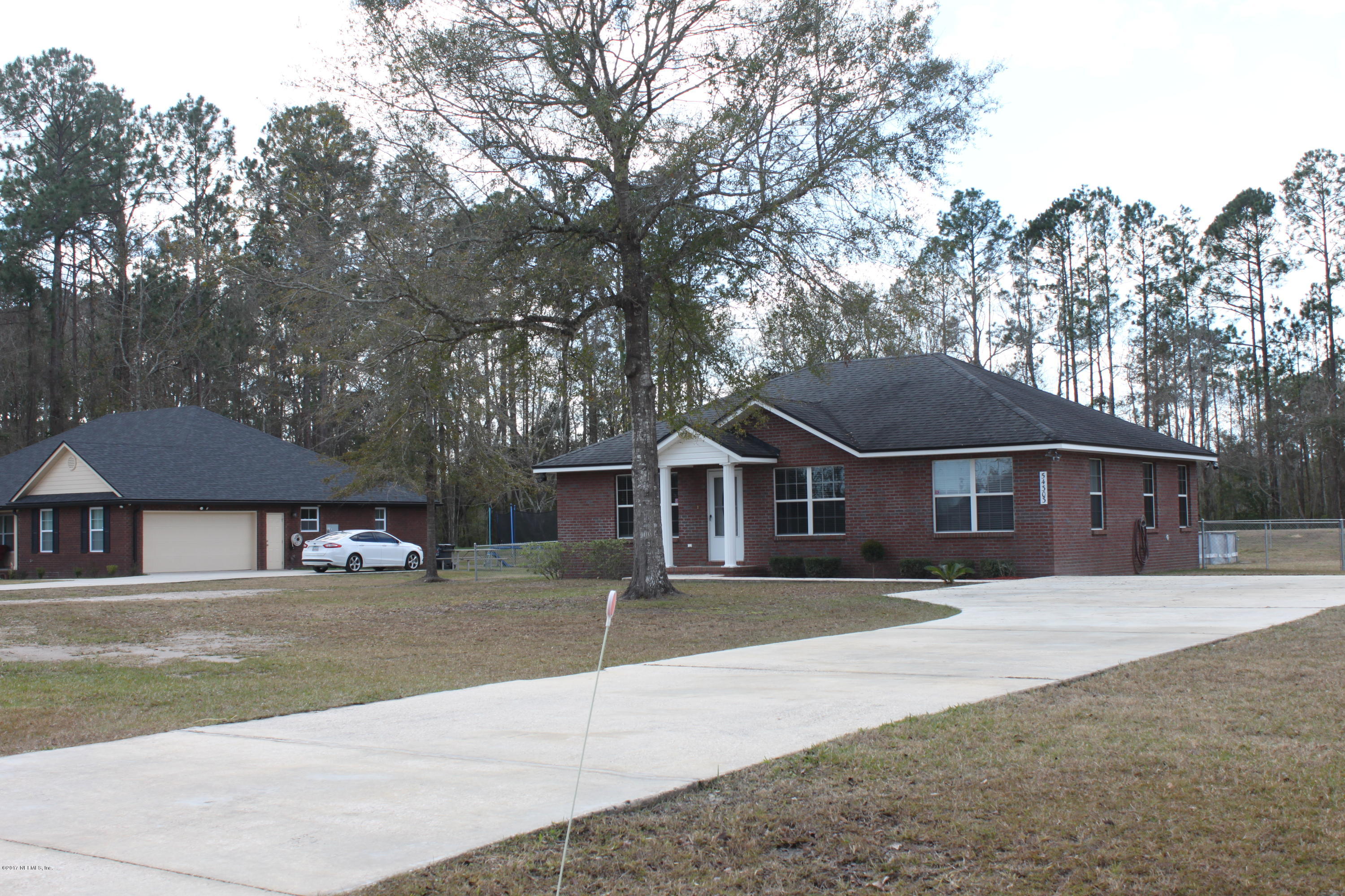 54303 Cravey Road Callahan, FL 32011 - Photo 1 of 13 front view of a house with a patio
