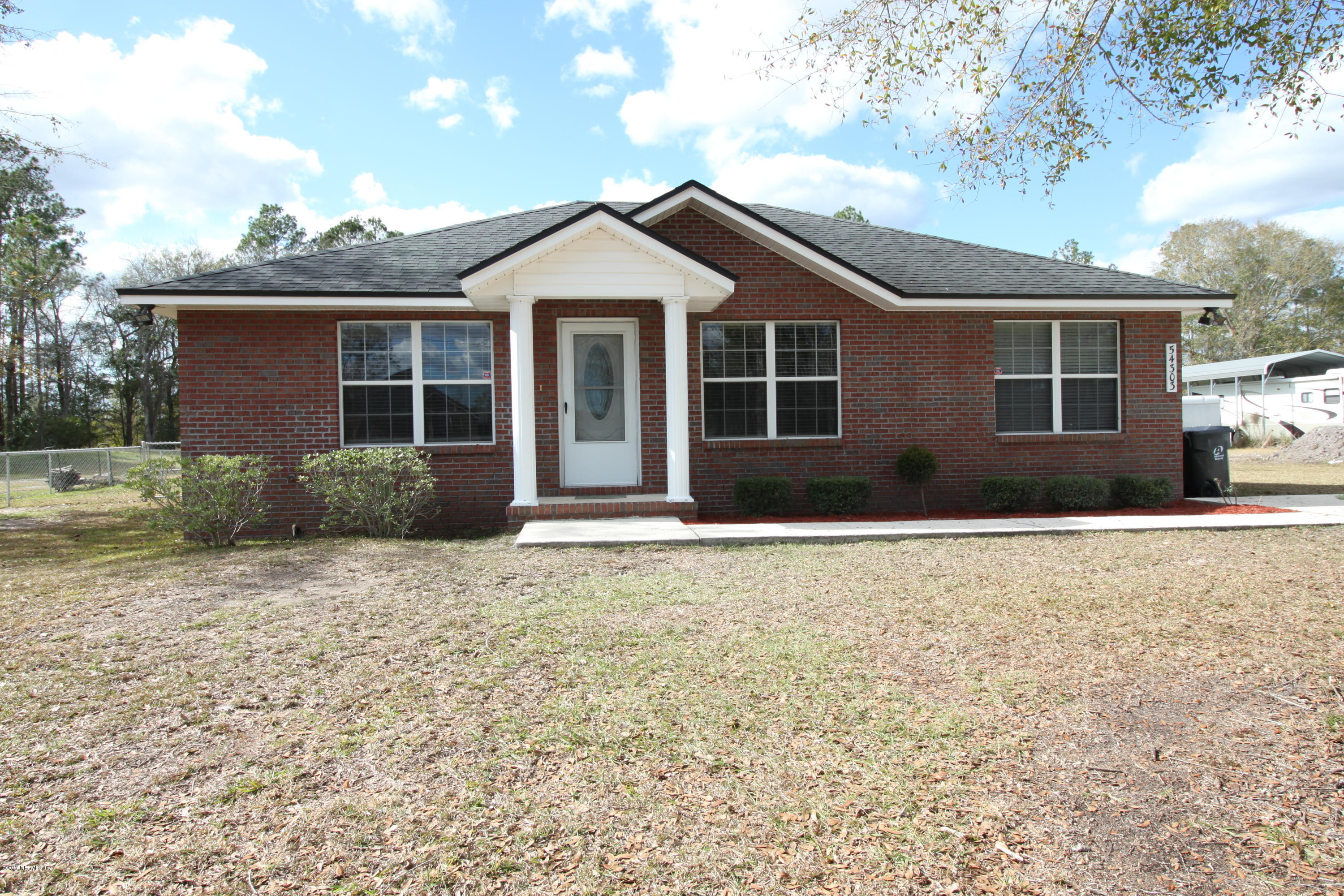 54303 Cravey Road Callahan, FL 32011 - Photo 2 of 13 a front view of a house with garden