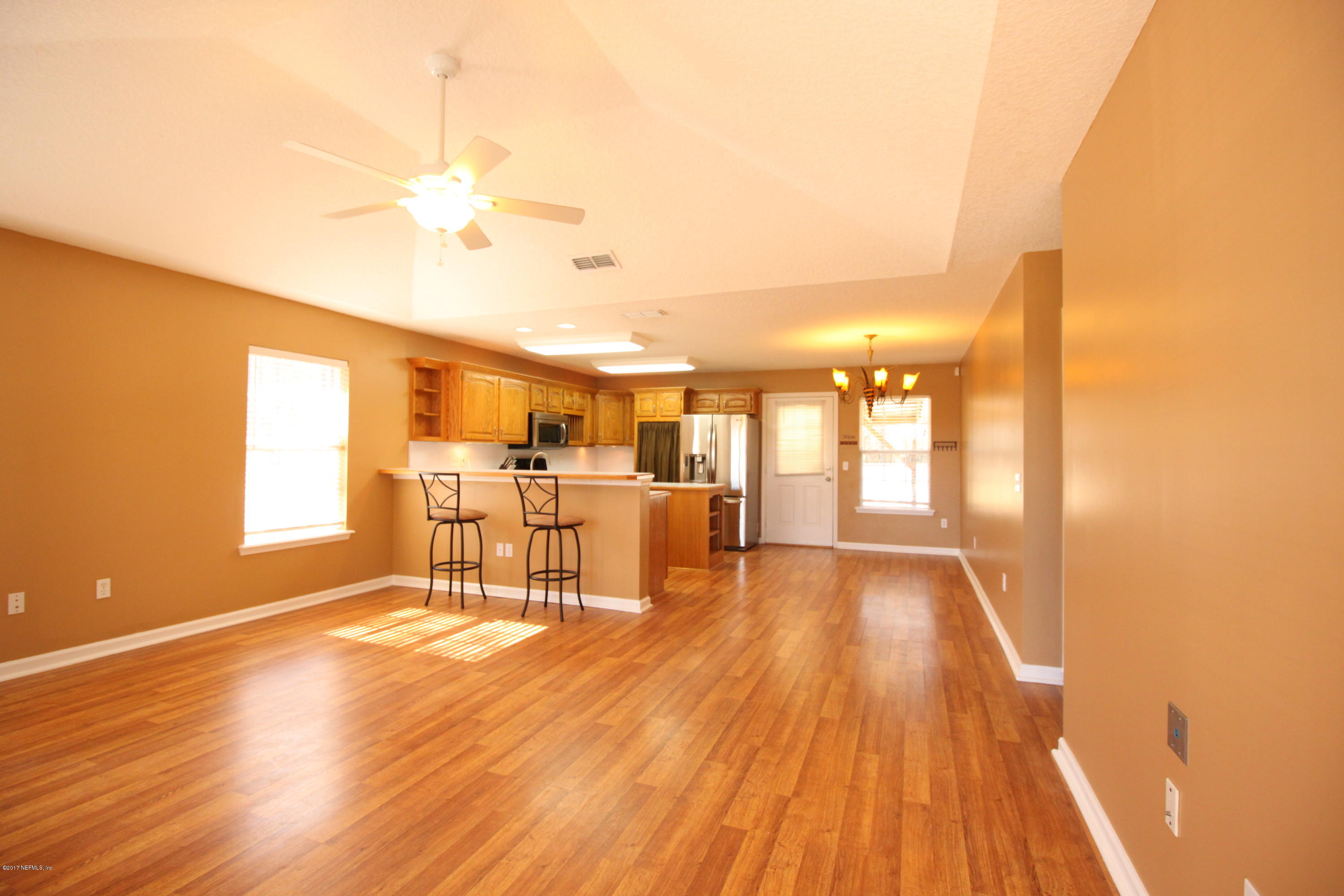 54303 Cravey Road Callahan, FL 32011 - Photo 3 of 13 a dining room with furniture and wooden floor