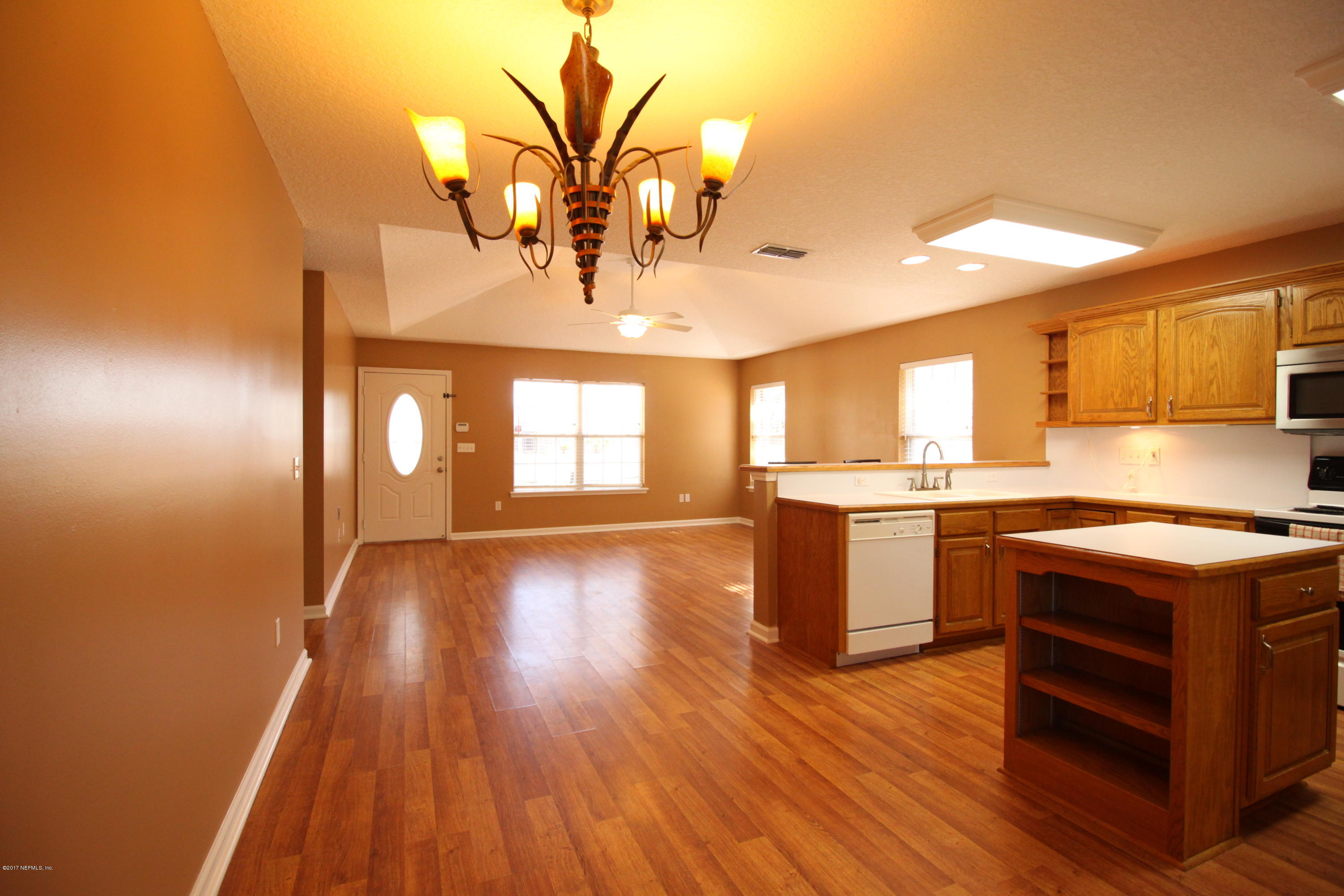 54303 Cravey Road Callahan, FL 32011 - Photo 6 of 13 a kitchen with a sink and wooden floor