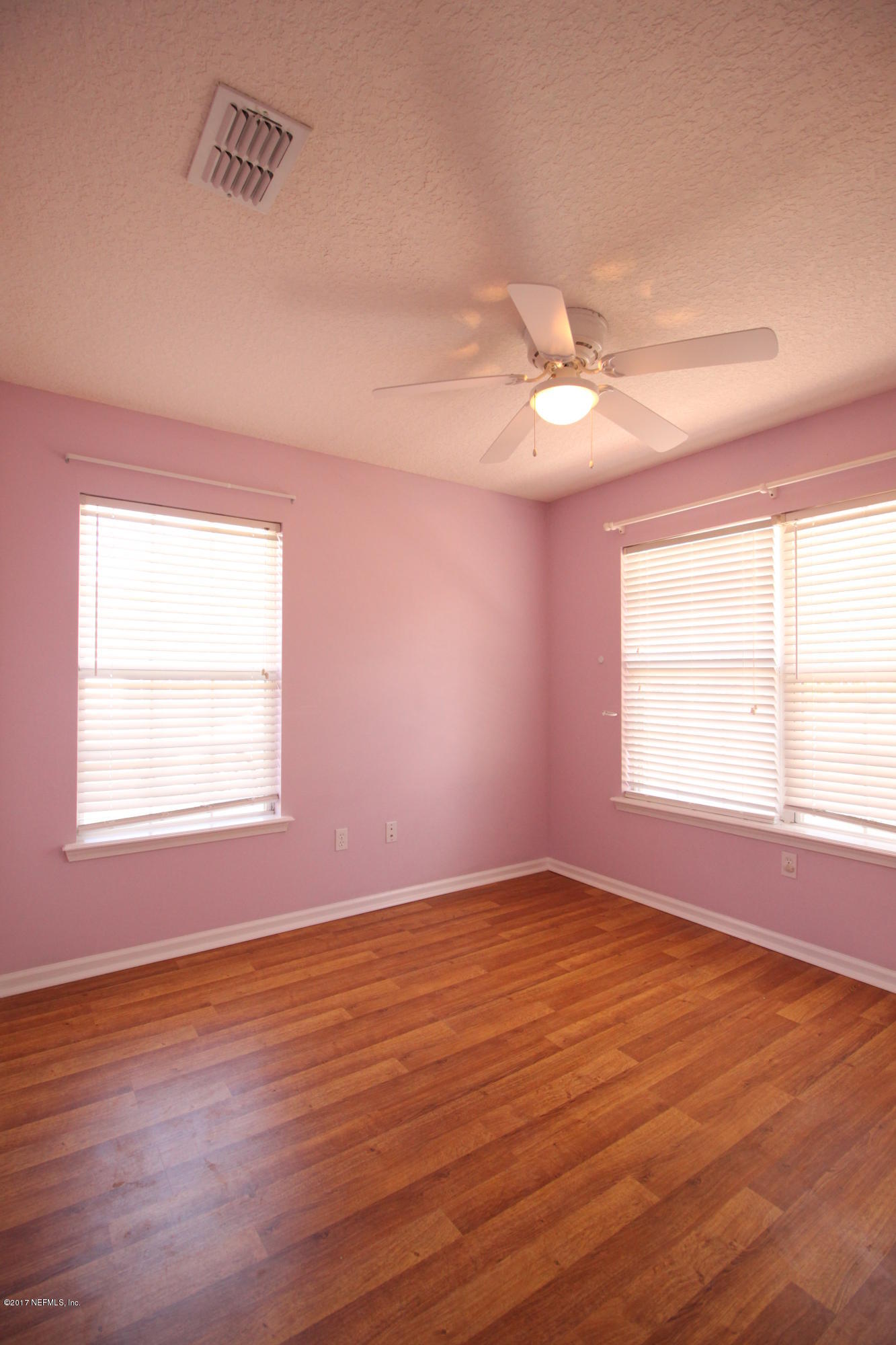54303 Cravey Road Callahan, FL 32011 - Photo 8 of 13 an empty room with wooden floor and windows