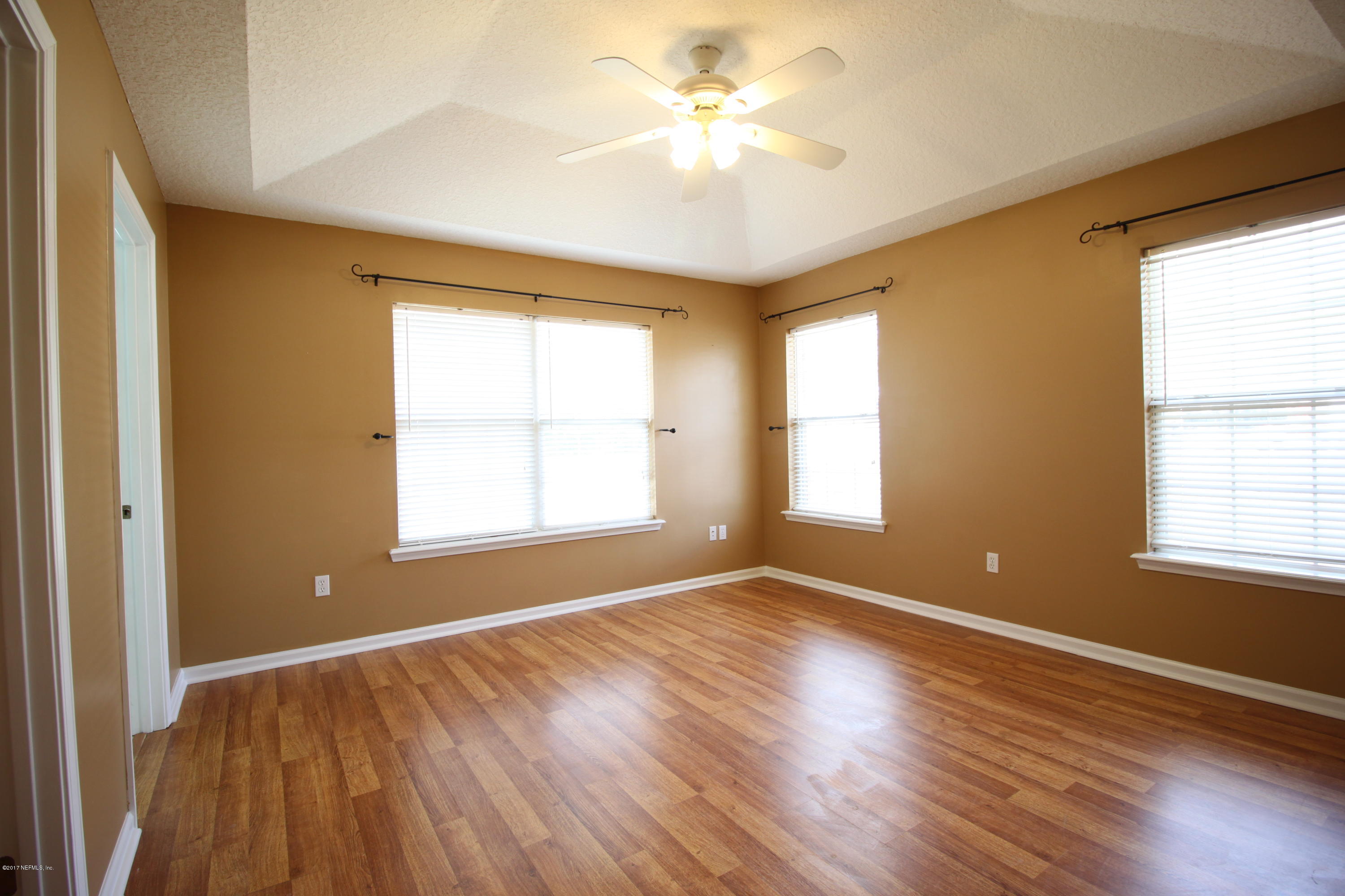 54303 Cravey Road Callahan, FL 32011 - Photo 10 of 13 a view of an empty room with a window and wooden floor