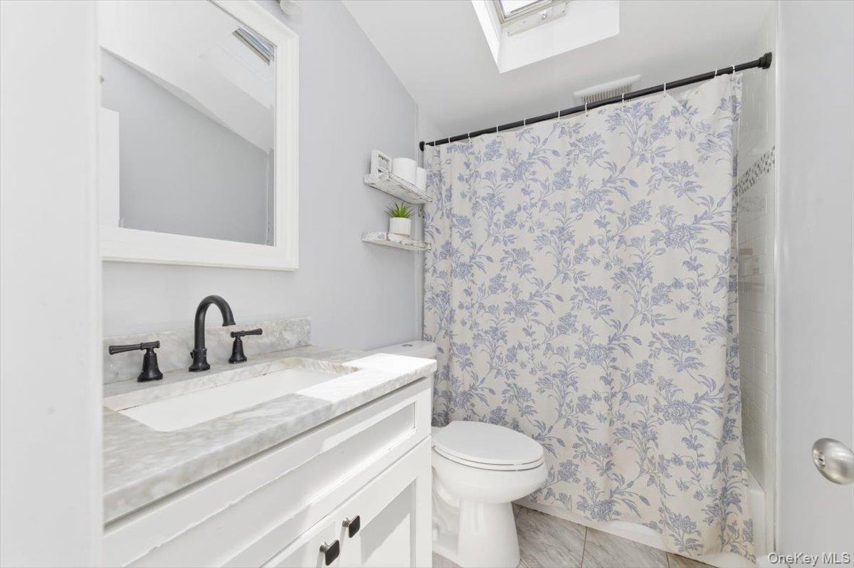 10 Rutgers Road Farmingville, NY 11738 - Photo 20 of 27 a bathroom with a granite countertop sink and a toilet