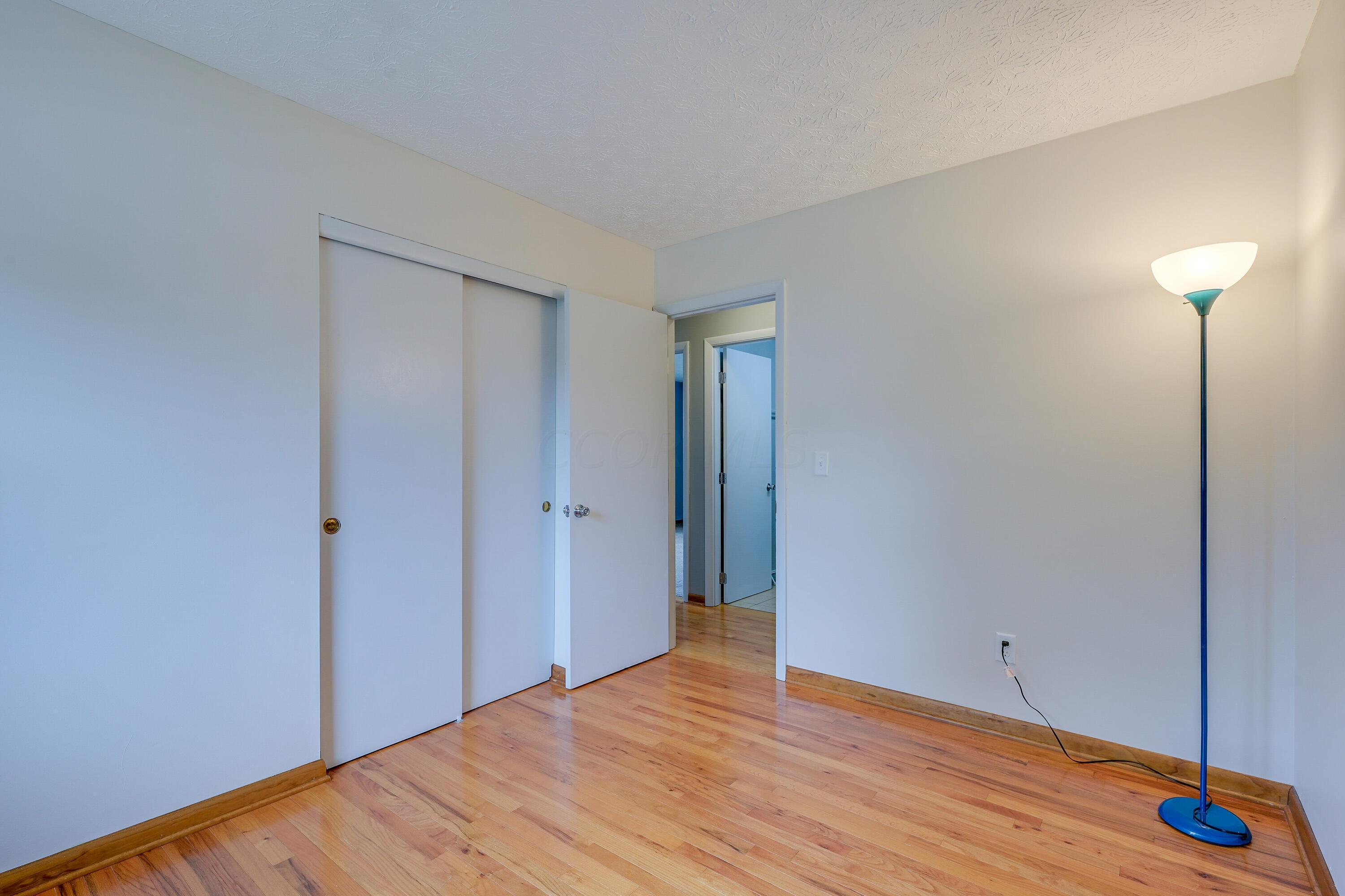5383 Pine Bluff Road Columbus, OH 43229 - Photo 21 of 32 Bedroom #3 with double closet and beautiful hardwood floors