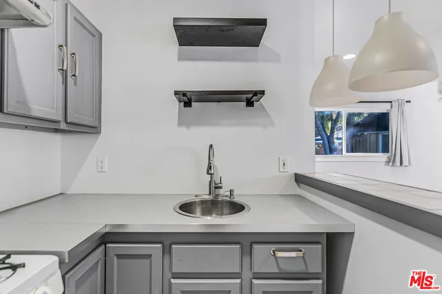 a kitchen with stainless steel appliances granite countertop a refrigerator and a stove