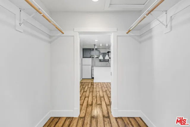 a view of empty room with wooden floor