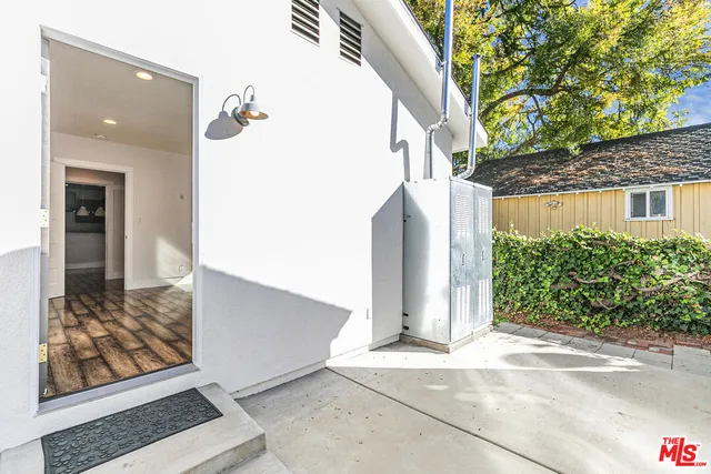 a workspace with wooden floor a ceiling fan and windows